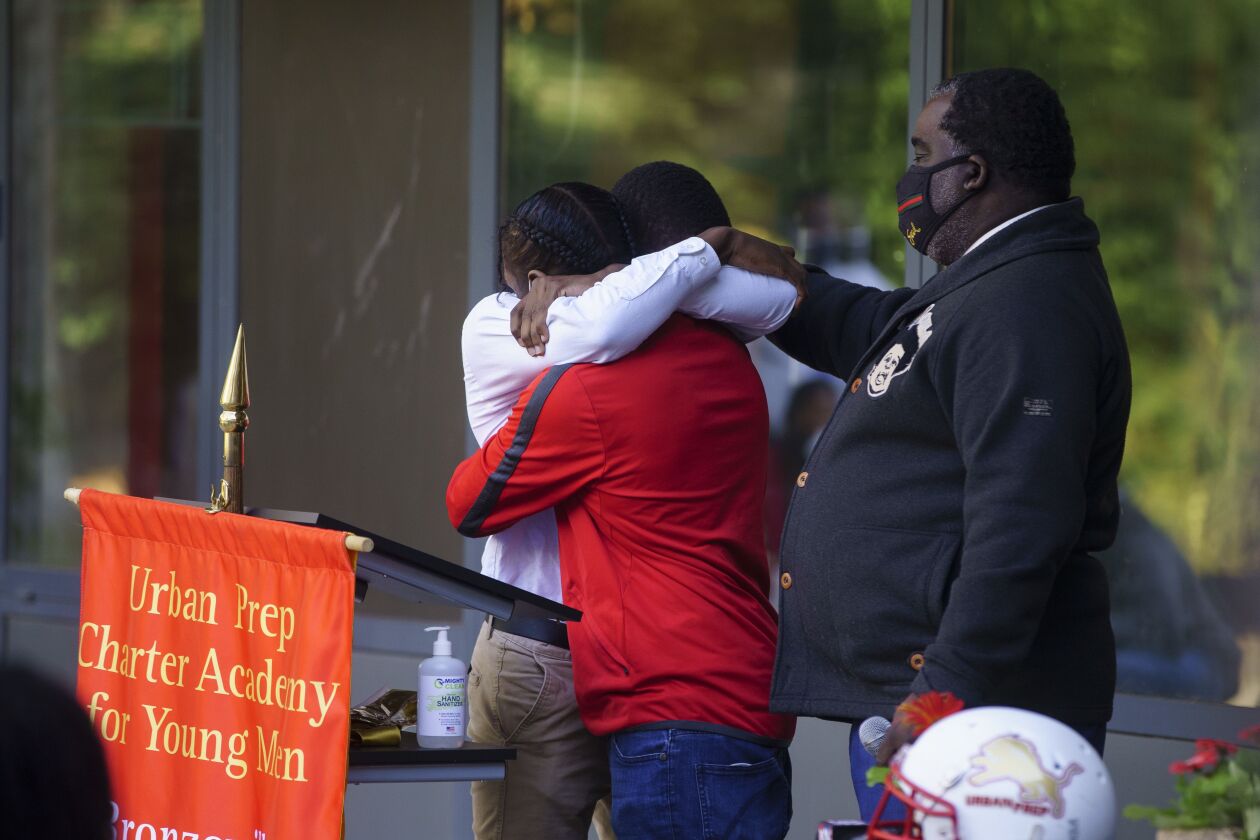 Two classmates hug one another after giving remarks during a memorial for Rashad Verner at Urban Prep Academy High School Bronzeville Campus.